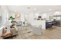 Bright open-concept space with modern decor, seamlessly flowing from the living area to the stylish kitchen at 1410 San Charles Dr, Dunedin, FL 34698