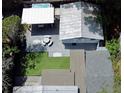 Aerial view of a backyard featuring an in-ground spa, lounge area, and putting green at 1515 E 31St Ave, Tampa, FL 33610