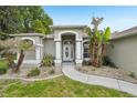 Close-up of the home's entrance, showcasing an elegant front door and decorative landscaping at 2016 Alameda Dr, Spring Hill, FL 34609