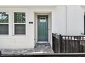 Inviting townhouse exterior with a dark teal front door, leading to a well-maintained home at 3113 4Th N Ter, St Petersburg, FL 33713