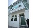Charming townhouse featuring a dark teal front door, white walls, and large windows at 3113 4Th N Ter, St Petersburg, FL 33713