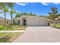 Inviting single-story home with a spacious three-car garage and well-maintained landscaping in a desirable neighborhood at 3321 Mapleridge Dr, Lutz, FL 33558