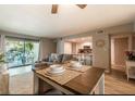Open-concept living room featuring a dining area, modern kitchen, and inviting decor at 3540 42Nd S St # F, St Petersburg, FL 33711