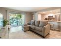 Comfortable living room with a plush sectional sofa and sliding glass doors to the patio at 3540 42Nd S St # F, St Petersburg, FL 33711