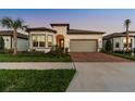 Inviting single-Gathering home with a brick driveway, two-car garage, and lush landscaping at 5858 Shorebird Br, Land O Lakes, FL 34638