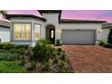 Charming single-Gathering home with a two-car garage, beautiful landscaping, and brick driveway at 5858 Shorebird Br, Land O Lakes, FL 34638