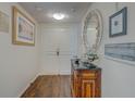 Inviting condo foyer featuring wood floors, elegant console table, and decorative mirror at 6 Belleview Blvd # 505, Belleair, FL 33756