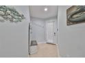 Light-filled hallway boasts coastal decor and tiled flooring at 6407 Mayra Shores Ln, Apollo Beach, FL 33572