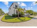Well-maintained home featuring lush green landscaping and a spacious front lawn, adding to its curb appeal at 923 Seagrape Dr, Ruskin, FL 33570