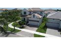 Beautiful two-story home featuring a two-car garage, tile roof, and lush landscaping at 923 Seagrape Dr, Ruskin, FL 33570
