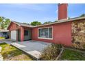 Charming home featuring a small deck area with seating, next to the driveway and the side yard at 11467 93Rd St, Largo, FL 33773