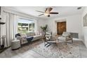 Cozy living room with neutral tones, comfortable seating, and a view to the front yard at 11467 93Rd St, Largo, FL 33773