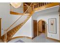 Grand foyer with a curved staircase, chandelier, and arched doorway at 1203 Parrilla De Avila, Tampa, FL 33613