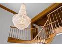 Low angle of staircase with a chandelier, wood railing, and trim at 1203 Parrilla De Avila, Tampa, FL 33613