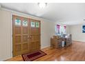 Inviting front entry with decorative doors, hardwood floors, and ample natural light at 12808 Candlewood Way, Hudson, FL 34667