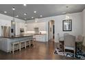 Open kitchen with a large island, modern lighting, stainless steel appliances, and a connected dining area at 150 Chippewa Ave, Tampa, FL 33606