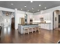 Bright, open kitchen with white cabinets, large island with seating, and modern stainless steel appliances at 150 Chippewa Ave, Tampa, FL 33606