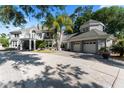 Beautiful home showcasing architectural design, attached two-car garage, and driveway space at 15702 Richboro Ct, Tampa, FL 33647