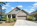 Inviting single-story home with a well-kept lawn, two-car garage, and a covered front porch area at 15861 Starling Water Dr, Lithia, FL 33547