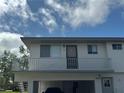 Close-up of a two-story condo building with a balcony, emphasizing the building's facade at 1830 Bough Ave # 4, Clearwater, FL 33760