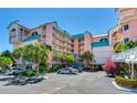 Beautiful tropical condo building with palm trees and parking at 18400 Gulf Blvd # 1211, Indian Shores, FL 33785
