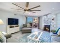 Living room with modern furnishings, fireplace, and sliding glass door to balcony at 18400 Gulf Blvd # 1211, Indian Shores, FL 33785