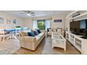 Living room with sofas, ceiling fan, wood-look floors, coastal decor, and dining room combo at 19823 Gulf Blvd # 42, Indian Shores, FL 33785