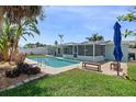 The backyard boasts a private pool, screened in patio, and lush tropical landscaping at 2310 Sunrise Se Dr, St Petersburg, FL 33705