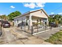 Single-story home with driveway and secure wrought iron fencing around a well-maintained front yard at 2818 N 19Th St, Tampa, FL 33605