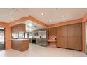 Well-equipped kitchen with stainless steel appliances, light countertops, bar seating, and tile flooring at 2932 Sweetgum S Way, Clearwater, FL 33761