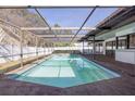 Inviting screened-in pool surrounded by a spacious patio, perfect for outdoor relaxation and entertaining at 2932 Sweetgum S Way, Clearwater, FL 33761