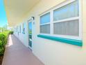 Exterior of a condominium, featuring a well maintained walkway with a bright white wall at 2960 59Th S St # 102, Gulfport, FL 33707