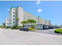 Condominium building featuring parking, palm trees, and well-maintained landscaping at 2960 59Th S St # 102, Gulfport, FL 33707
