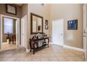Welcoming foyer with tile flooring, a large mirror, and ample space for decor at 3211 Grassglen Pl, Wesley Chapel, FL 33544