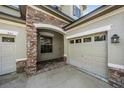 Charming front entrance featuring stone accents, arched entry, and a well-maintained facade at 3211 Grassglen Pl, Wesley Chapel, FL 33544