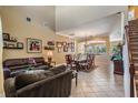 Inviting living room with tile floors, high ceilings, open to the dining area at 3211 Grassglen Pl, Wesley Chapel, FL 33544