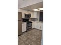 Updated kitchen featuring stainless steel appliances, white cabinets, and modern backsplash at 3321 Laurel View Dr, Brandon, FL 33511