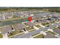An aerial view of a home in a Gathering-friendly neighborhood with pond access at 36734 Goffaux Loop, Zephyrhills, FL 33541