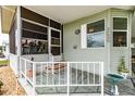 Welcoming front porch with screened in area and decorative accents at 37539 Landis Ave, Zephyrhills, FL 33541
