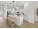 Bright, open kitchen with large island, modern pendant lighting, and stainless steel appliances at 4951 Ribbon Rock Cv, Lakewood Ranch, FL 34211