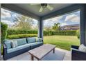 Inviting covered patio with comfortable seating and a view of the beautifully landscaped backyard at 5825 Jasper Glen Dr, Lithia, FL 33547