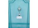 Close up of unit front door with classic hardware and aqua paint at 6020 Shore S Blvd # 903, Gulfport, FL 33707