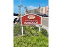 Welcome to the Windsor sign with landscaping and palm trees at 6020 Shore S Blvd # 903, Gulfport, FL 33707