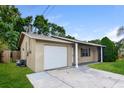 Side view of house showing garage, and entry at 7338 Coventry Dr, Port Richey, FL 34668