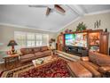 Inviting living room with hardwood floors, ceiling fan, and large windows at 7944 Royal Hart Dr, New Port Richey, FL 34653