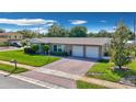 Beautiful single-story home with a brick driveway and a manicured front lawn at 8392 137Th Ln, Seminole, FL 33776