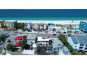 Stunning aerial view showcasing beachfront property with direct access to the white sand beach and ocean at 9921 Gulf Blvd, Treasure Island, FL 33706