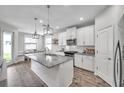 Bright kitchen with white cabinets, granite countertops, and stainless steel appliances at 12280 Lyon Pine Ln, Odessa, FL 33556