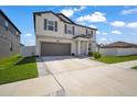 Two-story home with a two-car garage and green landscaping at 13227 Great Plains Dr, Riverview, FL 33579