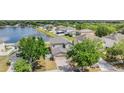 An aerial view of a home with a view of a nearby pond and a neighborhood at 13511 Fladgate Mark Dr, Riverview, FL 33579